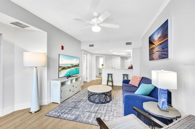 living room featuring ceiling fan and light hardwood / wood-style floors