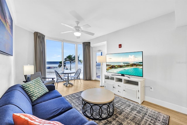 living room featuring light hardwood / wood-style flooring and ceiling fan