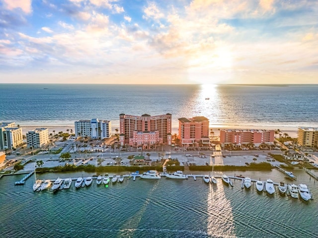 aerial view at dusk featuring a water view