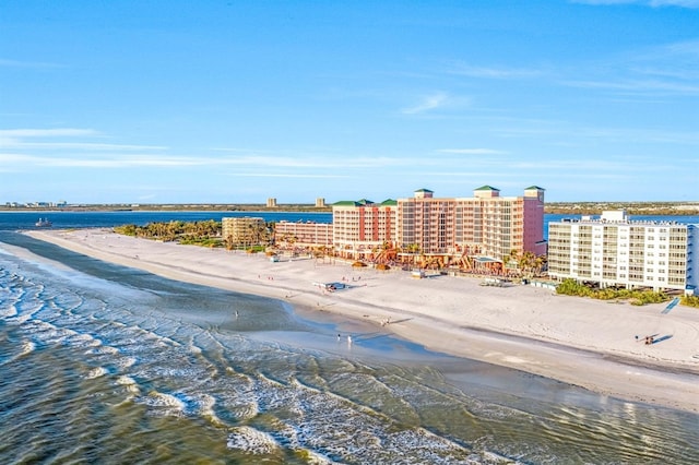 birds eye view of property with a water view and a beach view