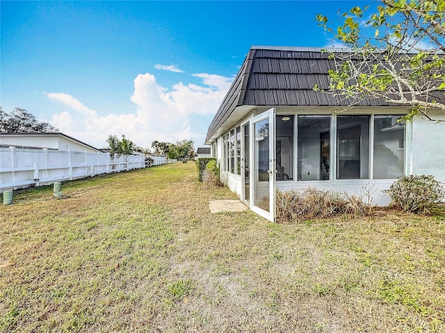 view of yard featuring a sunroom