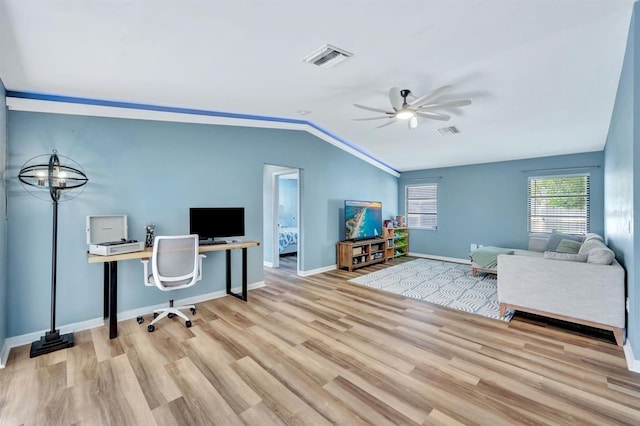 office space featuring ceiling fan, lofted ceiling, and light hardwood / wood-style flooring