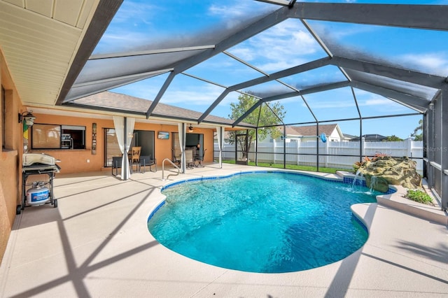 view of swimming pool with a lanai, a patio area, pool water feature, and area for grilling