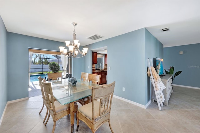 dining space with sink, light tile patterned flooring, and an inviting chandelier