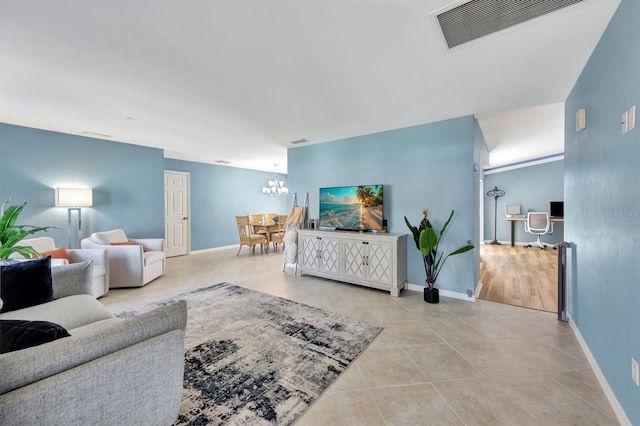 tiled living room featuring an inviting chandelier