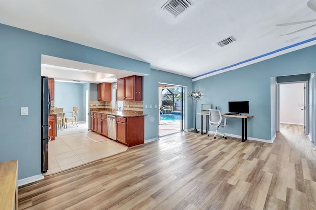 kitchen with stainless steel dishwasher, refrigerator, light stone countertops, and light hardwood / wood-style flooring