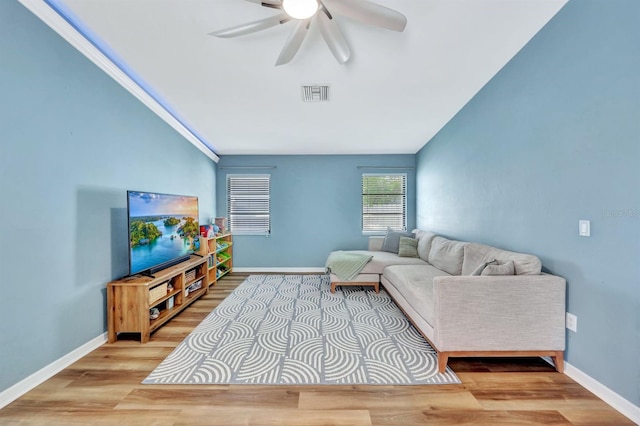 living room featuring light hardwood / wood-style floors, ceiling fan, and ornamental molding