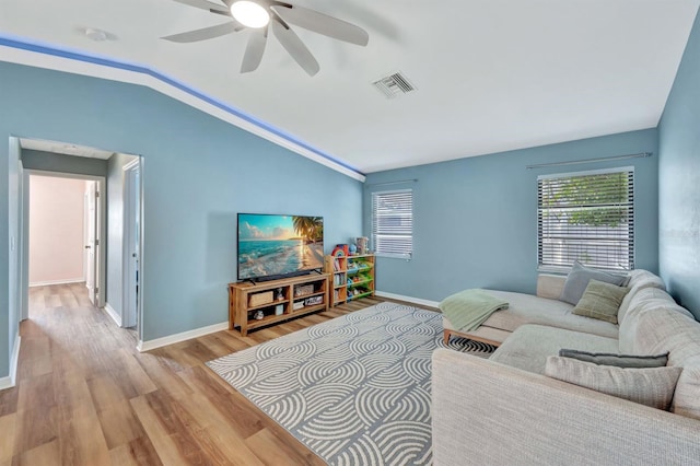 living room with ceiling fan, light hardwood / wood-style flooring, and lofted ceiling