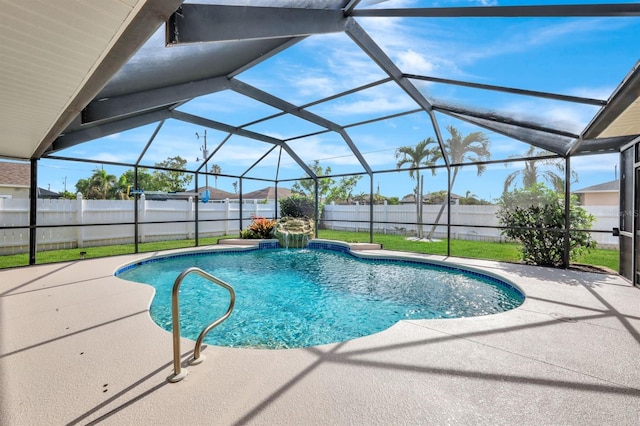 view of pool with a patio and glass enclosure