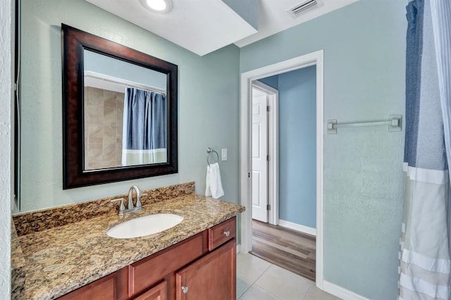 bathroom with tile patterned flooring, vanity, and a shower with shower curtain