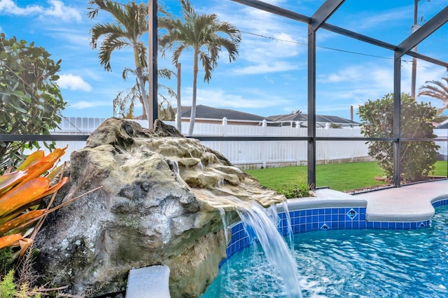 view of swimming pool with glass enclosure and pool water feature