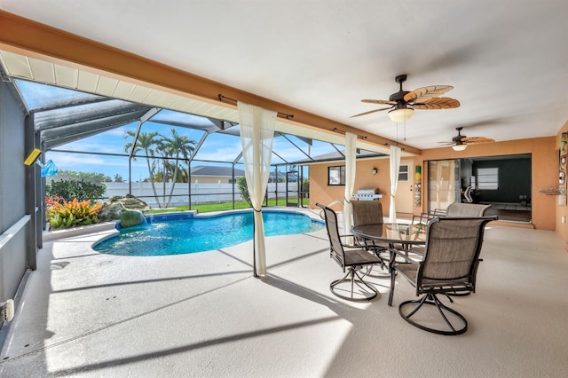 view of swimming pool featuring pool water feature, a patio area, ceiling fan, and a lanai