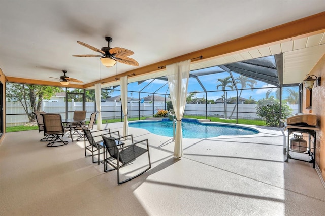 view of swimming pool with a patio area and a lanai