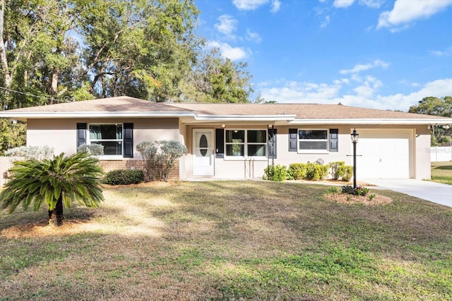 ranch-style house featuring a garage and a front lawn