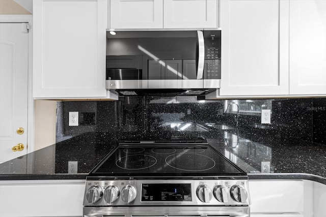 kitchen featuring white cabinets, backsplash, and appliances with stainless steel finishes