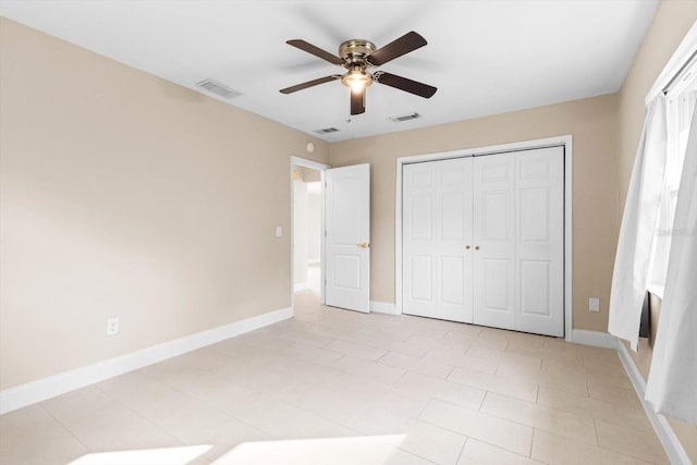 unfurnished bedroom with a closet and ceiling fan