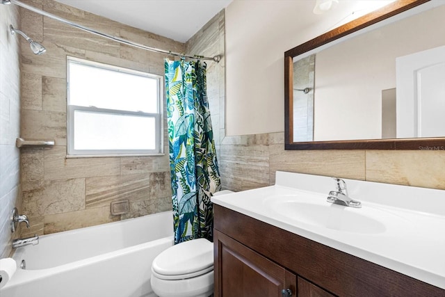 full bathroom with shower / bath combo with shower curtain, vanity, tile walls, and toilet