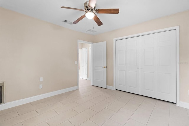 unfurnished bedroom with ceiling fan, light tile patterned flooring, and a closet