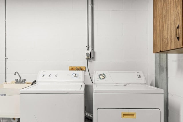 laundry room with separate washer and dryer and sink