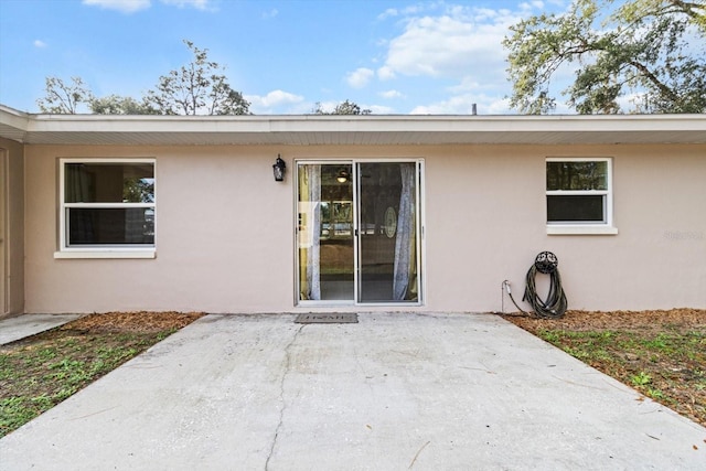 entrance to property with a patio