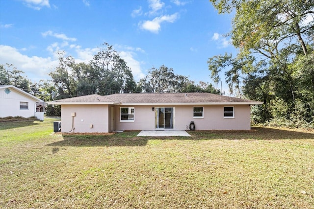 rear view of house with a lawn, central air condition unit, and a patio