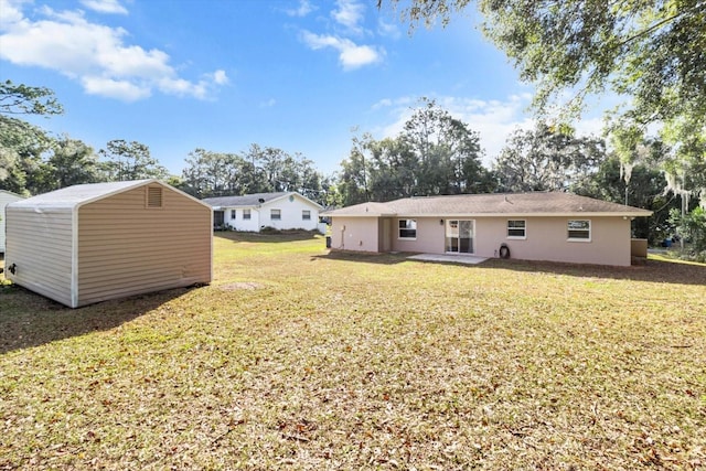 rear view of house featuring a yard and a patio