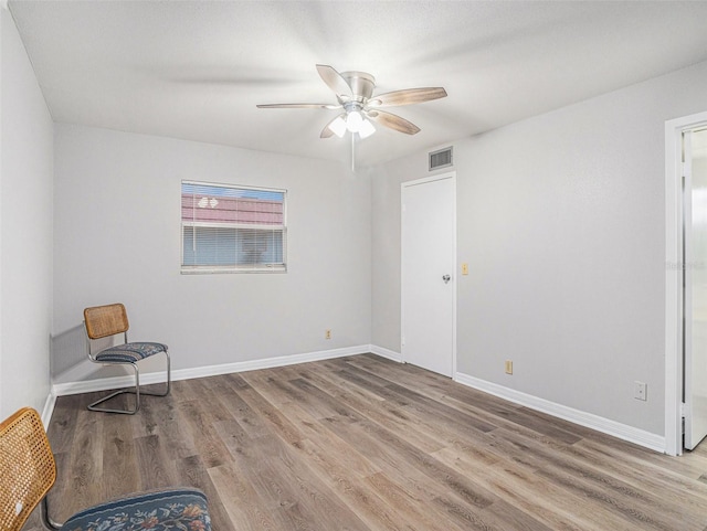 empty room featuring ceiling fan and hardwood / wood-style floors