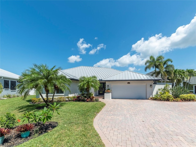 single story home featuring a garage and a front yard