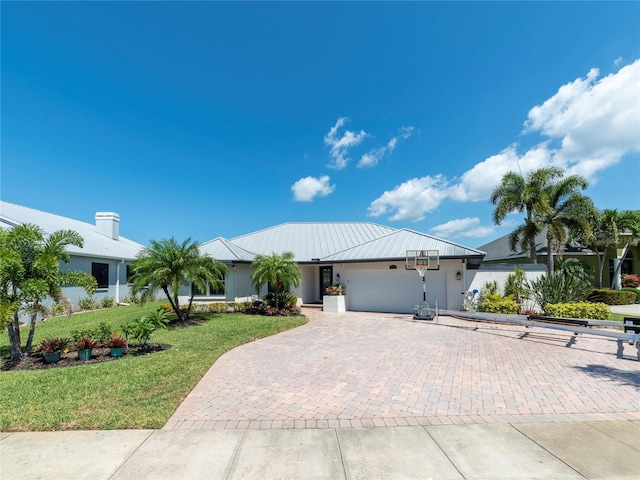 view of front of house with a garage and a front yard