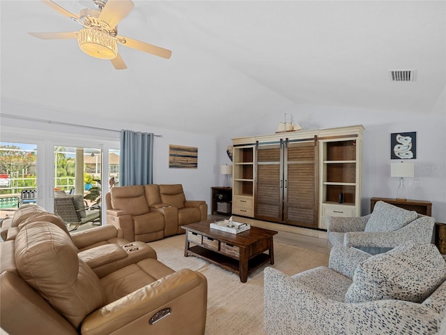 living room with ceiling fan, light wood-type flooring, and vaulted ceiling