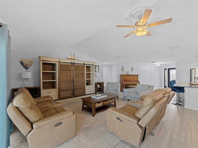 living room with ceiling fan, light wood-type flooring, and lofted ceiling