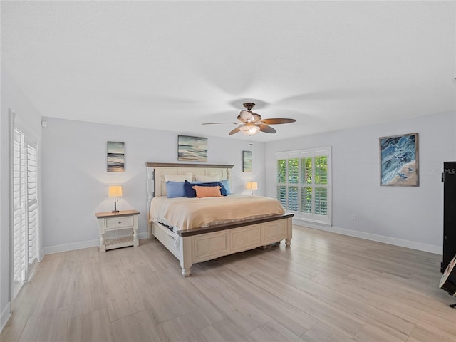 bedroom with light hardwood / wood-style floors and ceiling fan