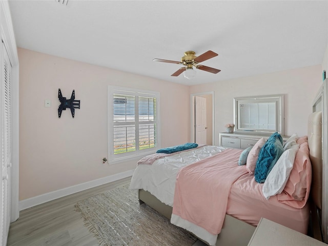 bedroom featuring a closet, light hardwood / wood-style flooring, and ceiling fan