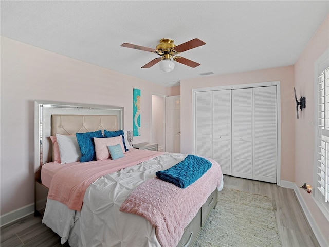 bedroom featuring a closet, ceiling fan, and light hardwood / wood-style floors