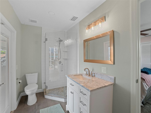 bathroom featuring toilet, vanity, tile patterned floors, and walk in shower