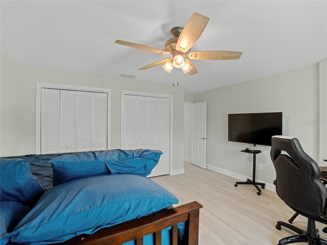 office space with light hardwood / wood-style floors and ceiling fan