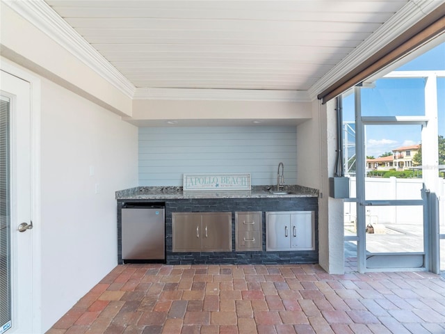 view of patio / terrace featuring an outdoor kitchen and sink