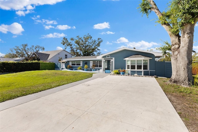 ranch-style house featuring a front lawn