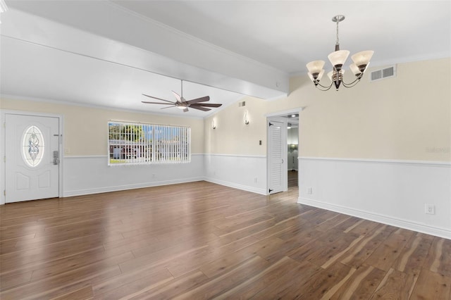 unfurnished living room featuring lofted ceiling with beams, crown molding, dark wood-type flooring, and ceiling fan with notable chandelier