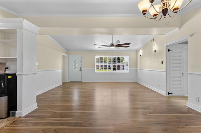 unfurnished living room featuring hardwood / wood-style flooring, ceiling fan with notable chandelier, and ornamental molding