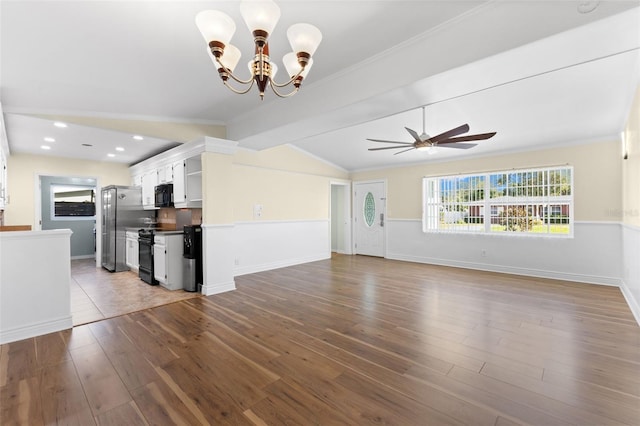 unfurnished living room featuring hardwood / wood-style floors, vaulted ceiling with beams, ornamental molding, and ceiling fan with notable chandelier