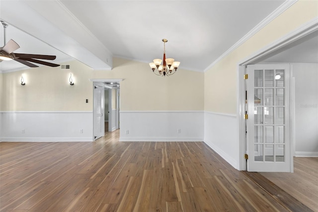 empty room with vaulted ceiling, crown molding, ceiling fan with notable chandelier, and dark hardwood / wood-style floors