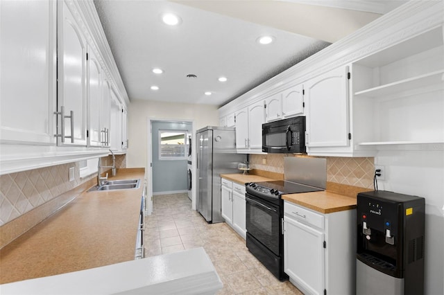 kitchen with backsplash, black appliances, white cabinets, sink, and light tile patterned flooring