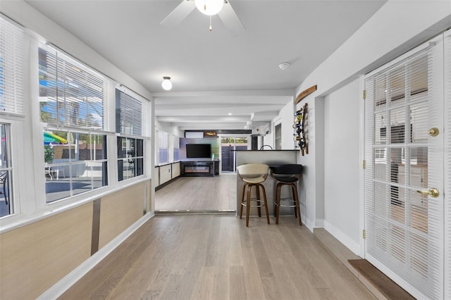 interior space featuring ceiling fan and beamed ceiling