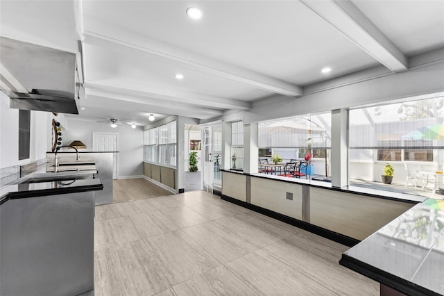 kitchen featuring beam ceiling, ceiling fan, sink, and light hardwood / wood-style floors