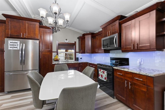 kitchen with backsplash, ornamental molding, stainless steel appliances, a chandelier, and hanging light fixtures