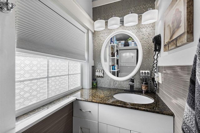 bathroom featuring vanity and tasteful backsplash