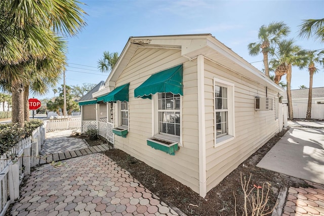 view of property exterior featuring a wall mounted AC