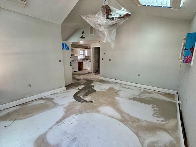 interior space featuring concrete flooring and vaulted ceiling