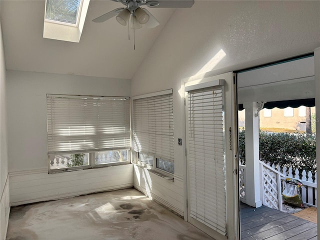 interior space featuring lofted ceiling with skylight and ceiling fan